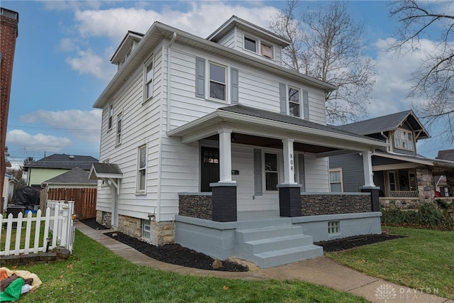 view of front of home with a porch and a front lawn