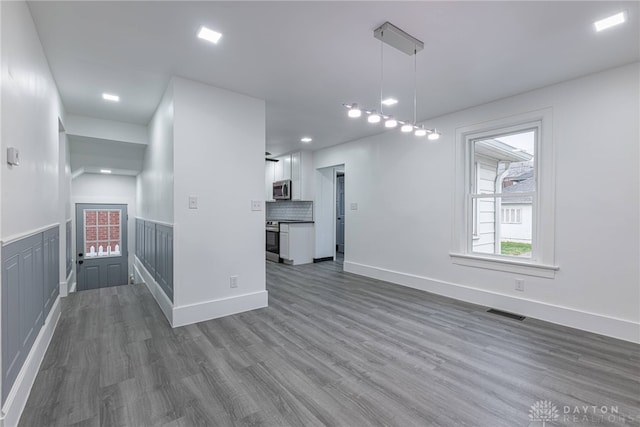 unfurnished living room featuring dark hardwood / wood-style floors