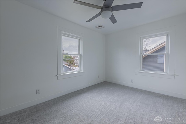 spare room featuring carpet floors and ceiling fan