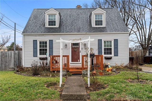 cape cod house with a front lawn