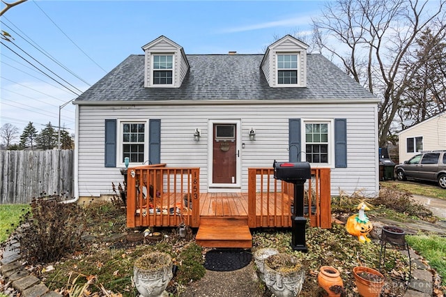 new england style home featuring a wooden deck