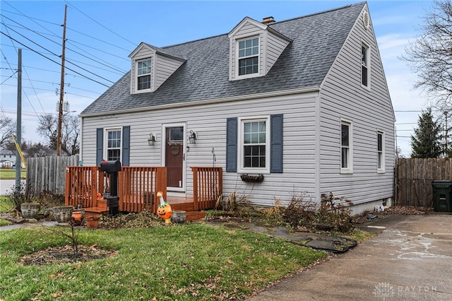 cape cod home with a front yard