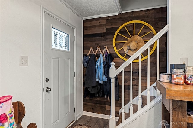 interior space with hardwood / wood-style flooring, wood walls, ornamental molding, and a textured ceiling