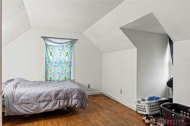 bedroom featuring hardwood / wood-style floors and lofted ceiling