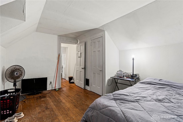 bedroom featuring dark wood-type flooring and lofted ceiling