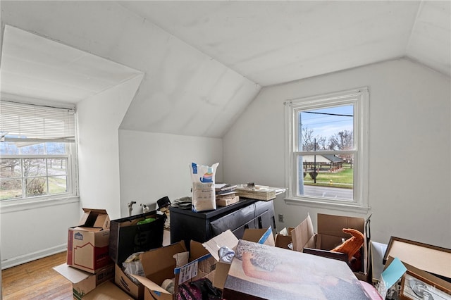 interior space featuring hardwood / wood-style flooring and vaulted ceiling