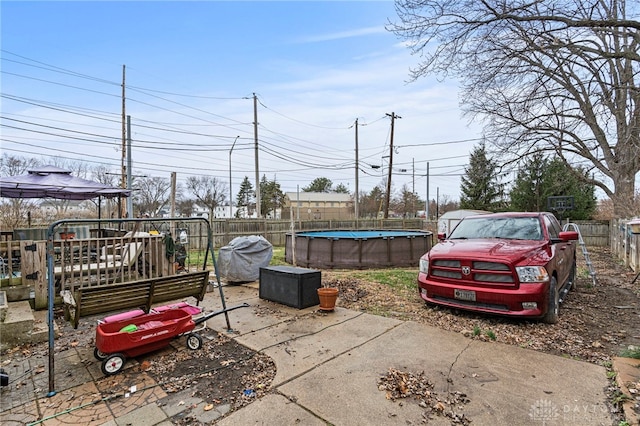 view of patio / terrace featuring a fenced in pool and a grill