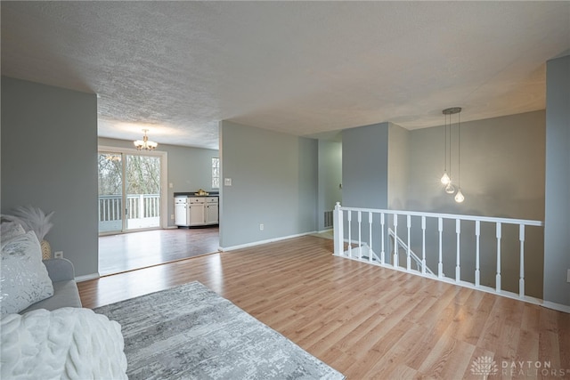 living room featuring a notable chandelier and light wood-type flooring