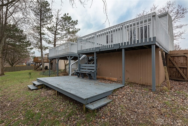 back of house featuring a deck and a yard