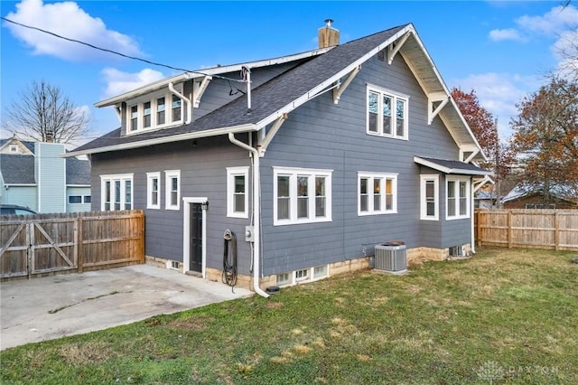 back of property featuring central AC unit, a yard, and a patio