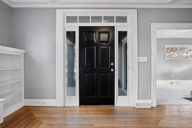 foyer entrance featuring crown molding