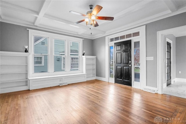 foyer featuring beamed ceiling, a wealth of natural light, coffered ceiling, and ceiling fan