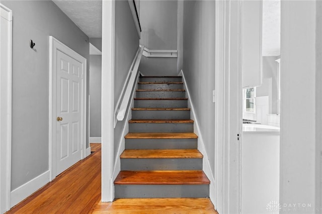 stairs featuring wood-type flooring