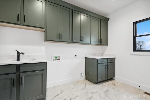 clothes washing area with marble finish floor, baseboards, hookup for a washing machine, a sink, and cabinet space