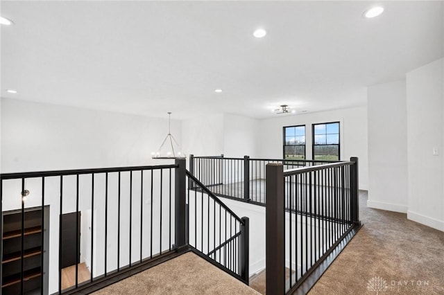 corridor featuring carpet flooring, recessed lighting, baseboards, and an upstairs landing