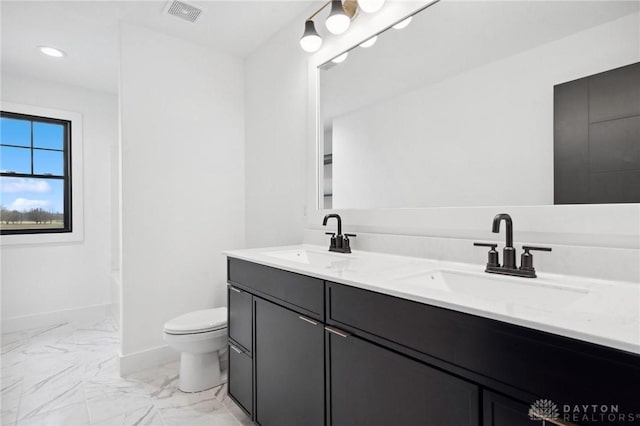 bathroom with toilet, visible vents, a sink, and marble finish floor