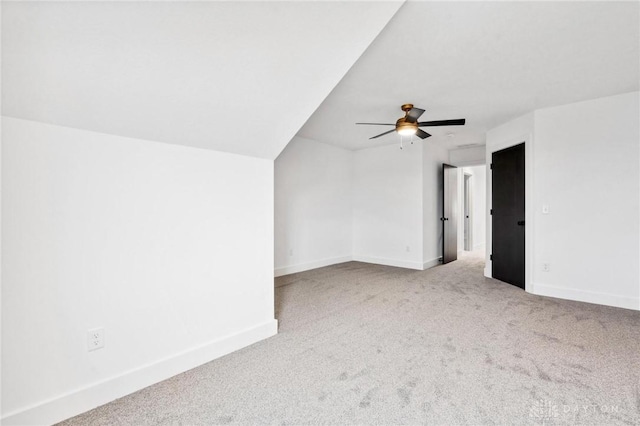 interior space featuring baseboards, a ceiling fan, and carpet flooring