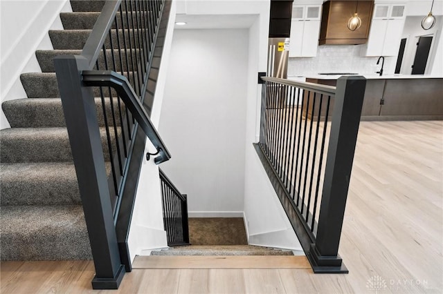 stairs with baseboards and wood finished floors