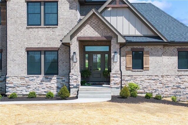 entrance to property with board and batten siding and brick siding