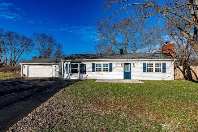 ranch-style home featuring a garage and a front lawn