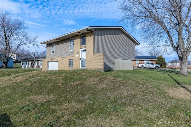 view of side of home with a lawn