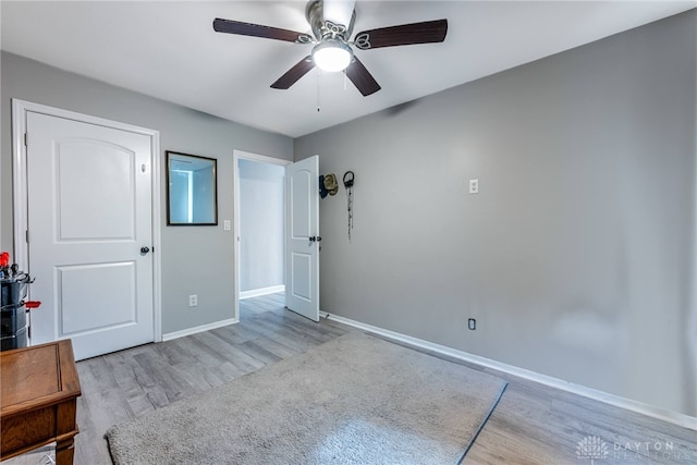 unfurnished bedroom with ceiling fan and light wood-type flooring