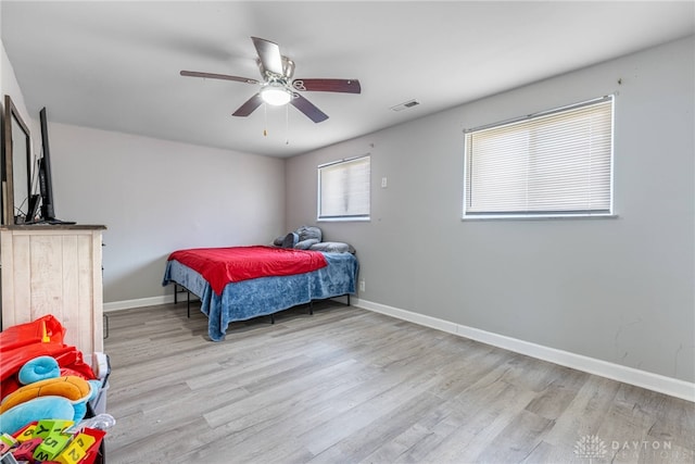 bedroom with light wood-type flooring and ceiling fan