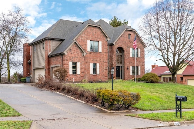 front of property with a front yard and a garage