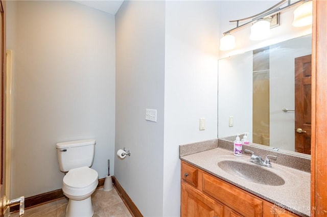 bathroom featuring tile patterned flooring, vanity, and toilet