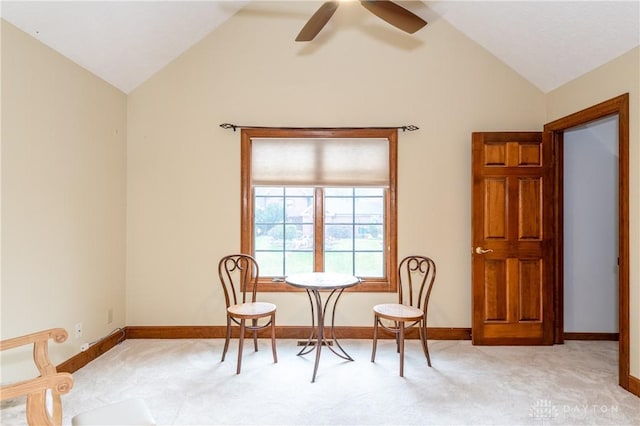 carpeted dining room with ceiling fan and vaulted ceiling