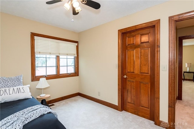 bedroom with light carpet and ceiling fan