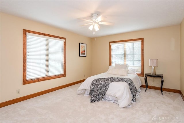 bedroom with ceiling fan and light carpet