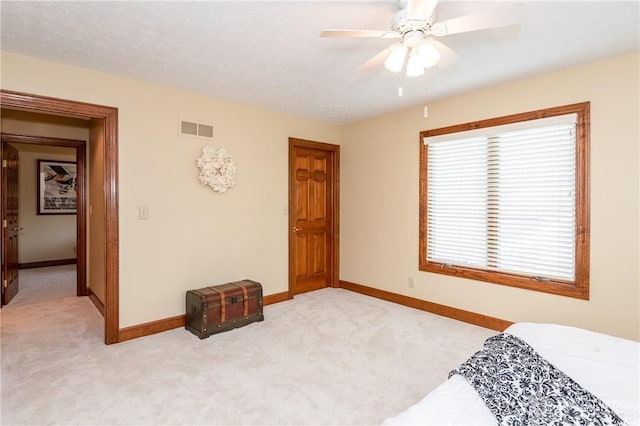 bedroom featuring light colored carpet and ceiling fan