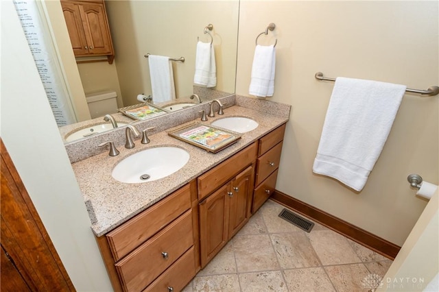 bathroom with vanity and toilet