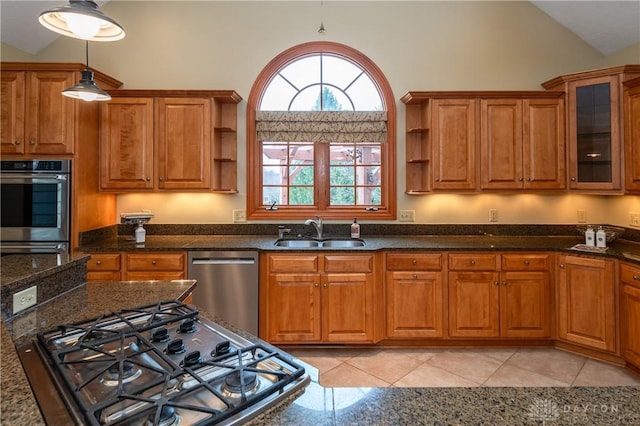 kitchen featuring light tile patterned flooring, vaulted ceiling, sink, and stainless steel appliances