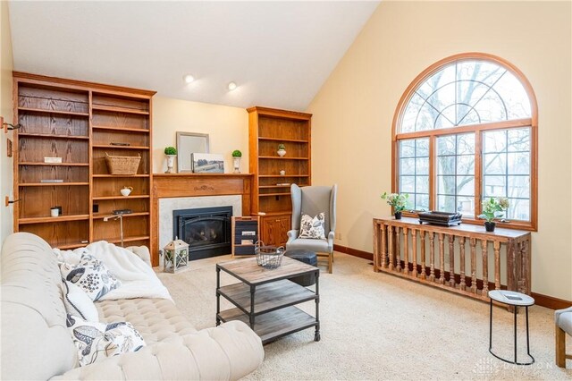 carpeted living room featuring vaulted ceiling and plenty of natural light