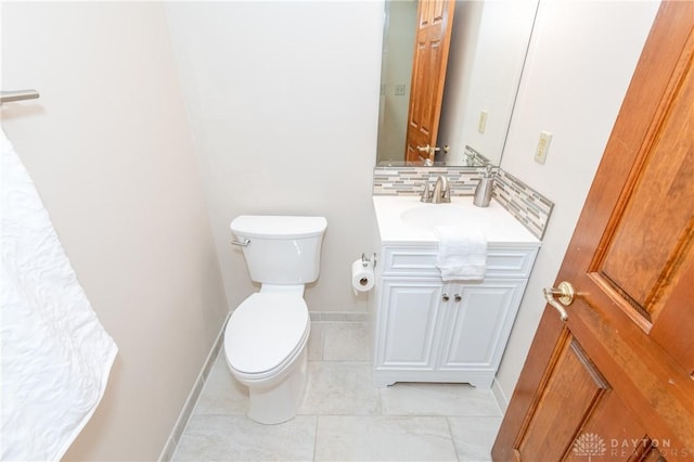 bathroom featuring decorative backsplash, vanity, and toilet