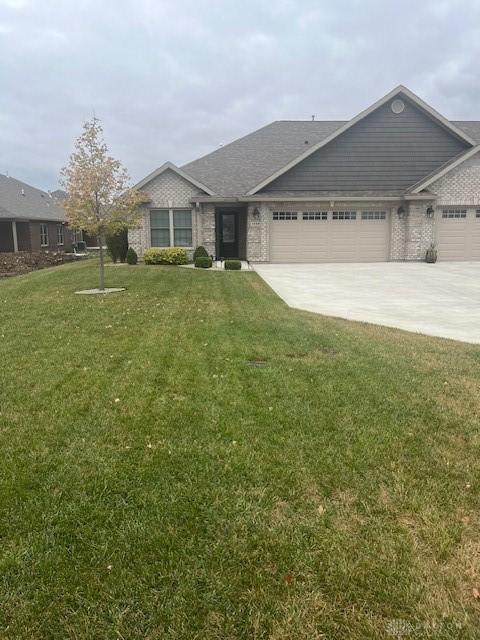 view of front of house with a garage and a front lawn