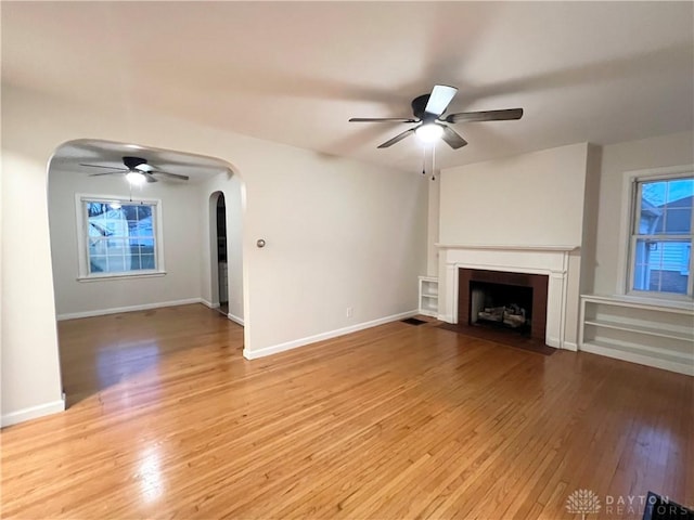 unfurnished living room featuring ceiling fan and light wood-type flooring