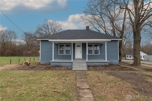 bungalow-style home with a porch and a front lawn