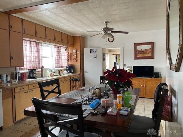 dining space with ceiling fan and light tile patterned flooring