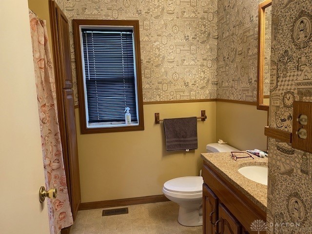 bathroom featuring vanity and toilet