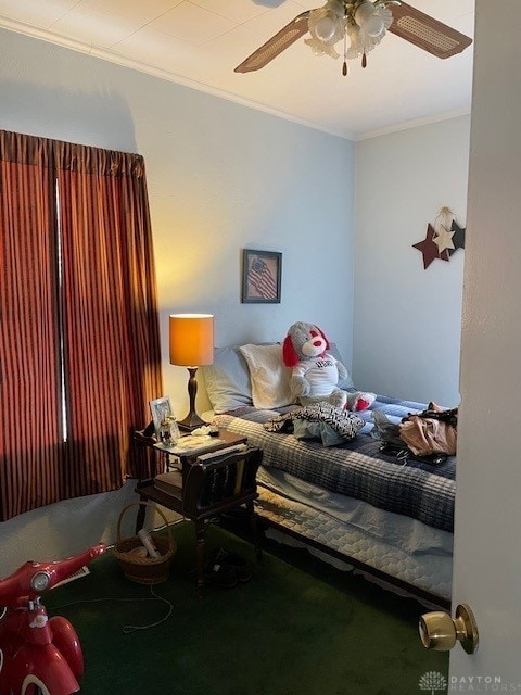 carpeted bedroom with ceiling fan and crown molding