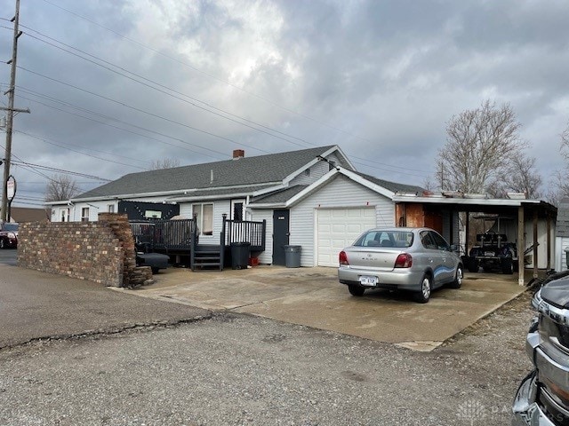 ranch-style home with a carport and a deck