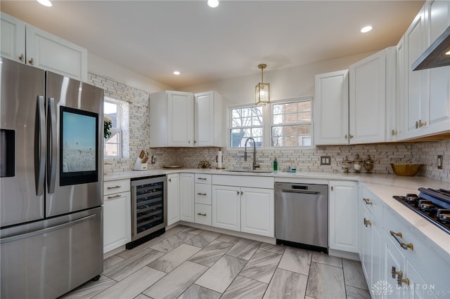 kitchen with white cabinets, stainless steel appliances, and wine cooler