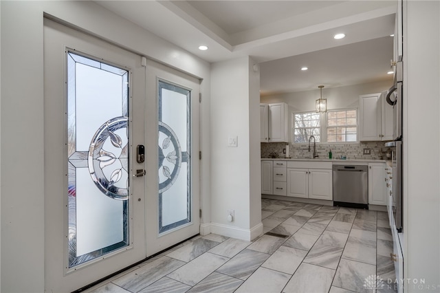 entrance foyer featuring french doors and sink