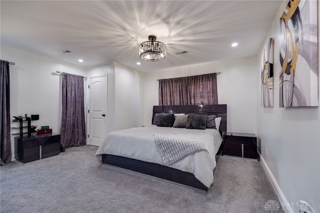 carpeted bedroom with a chandelier