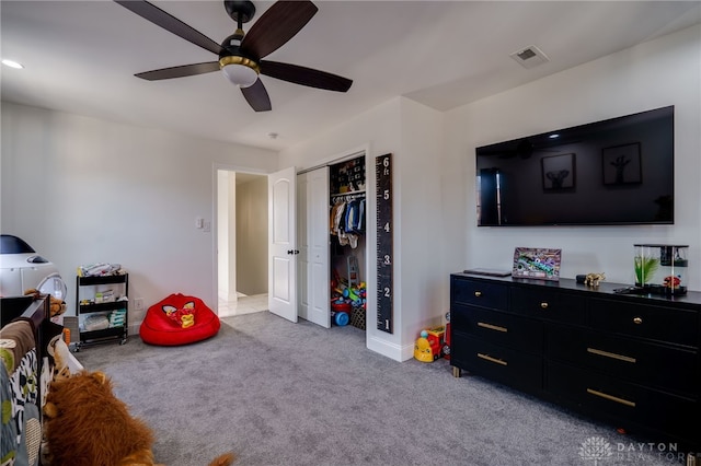 interior space featuring ceiling fan and a closet