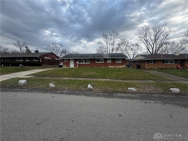 ranch-style home with a front lawn