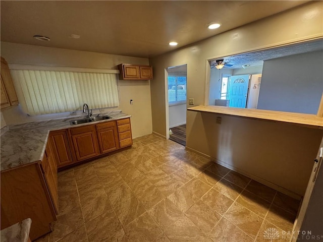 kitchen with ceiling fan and sink